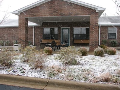 Entrance of Sunshine Manor with snowy landscape