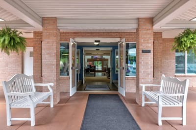 Entrance of a senior living facility with benches