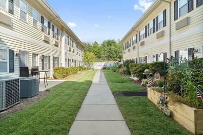 Well-maintained garden path between residential buildings