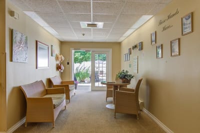 Bright interior hallway with seating and artwork