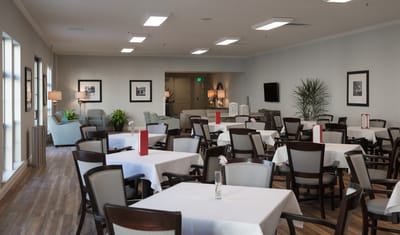 Bright dining room with tables set for meals