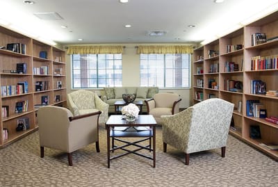 Cozy library area with comfortable seating and bookshelves