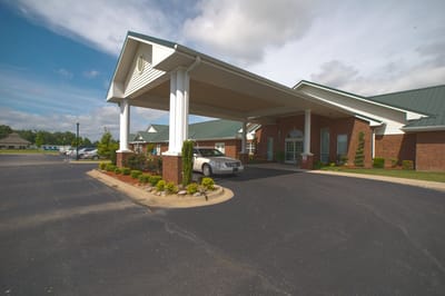 Exterior view of the facility entrance with covered drive-thru