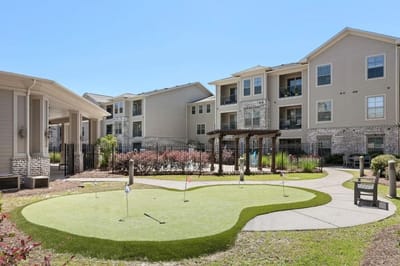 Outdoor putting green with residential buildings