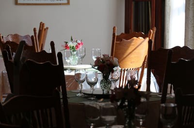 Dining room set with flowers and glassware