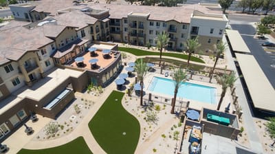 Aerial view of the senior living facility with pool and landscaping