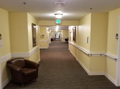Interior hallway with a chair and framed artwork