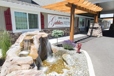 Exterior view of The Gables facility with water feature