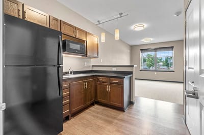 Interior view of a kitchenette and living area in a senior facility