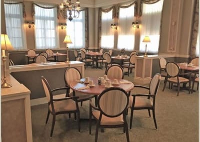 Dining area with tables and chairs in a well-lit room