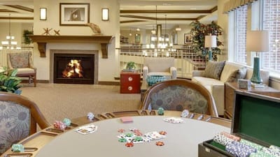 Cozy common area with a fireplace and card table