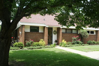 Exterior view of a building surrounded by trees and landscaping