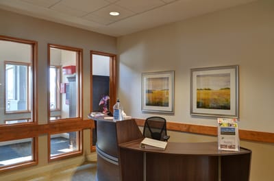 Bright reception area with art and seating
