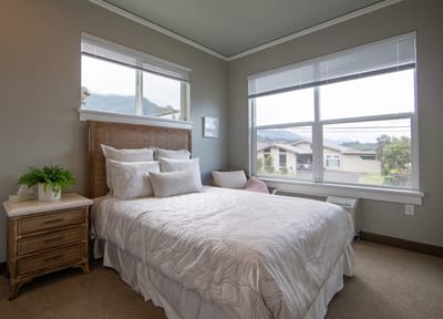 Bright and inviting resident bedroom with large windows