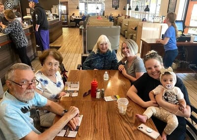 Residents and staff enjoying a meal together