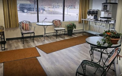 Bright common area with seating and coffee station