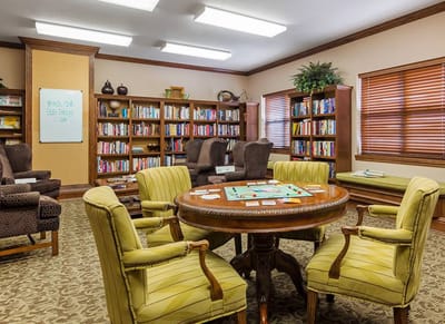 Bright common area with bookshelf and game table