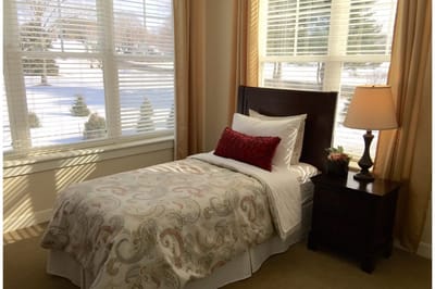 Cozy resident room with a bed and lamp