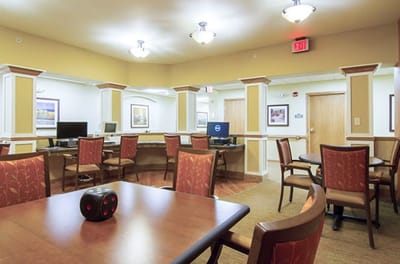 Common area with seating and computers for residents