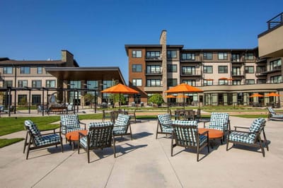 Outdoor seating area with poolside chairs and umbrellas