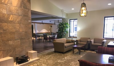 Cozy lobby area with chairs and fireplace