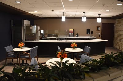 Bright common area with tables and flowers