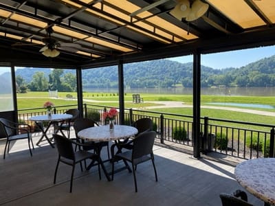 Patio area with tables overlooking a river