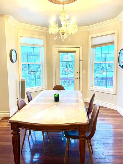 Bright dining room with large windows and wooden table