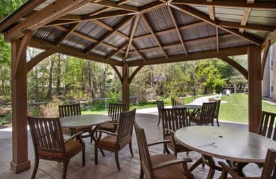 Covered outdoor seating area with tables and chairs