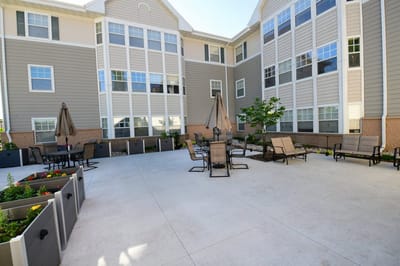 Outdoor patio area with seating and gardens