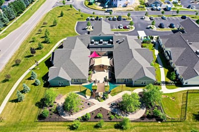 Aerial view of a senior care facility with landscaped grounds