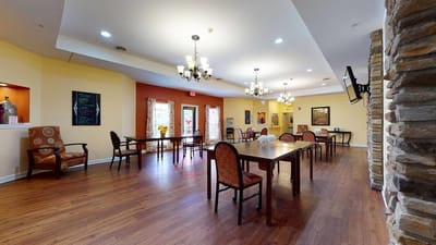 Common area with tables and chairs in a warm setting