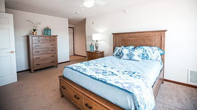 Bright and spacious bedroom with wooden furniture