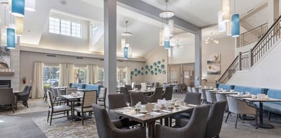 Bright, spacious dining room with tables set for meals
