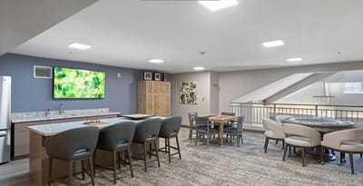 Bright interior common area with seating and gaming options