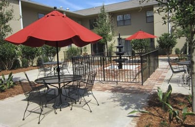 Outdoor sitting area with patio umbrellas and a fountain