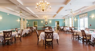 Dining area with tables and chairs in a bright room