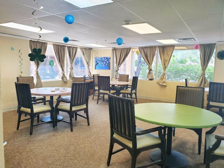 Bright activity room with tables and windows