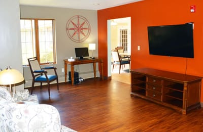 Bright common area with seating and a desk