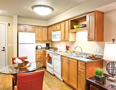 Bright kitchen area with dining table and appliances