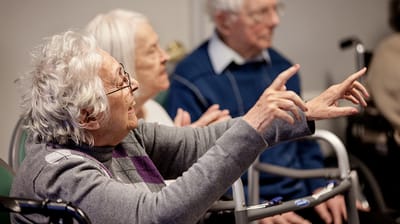 Senior resident joyfully participating in a group activity