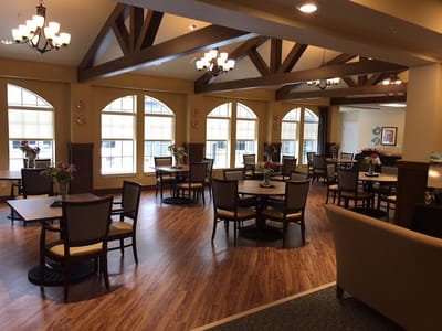 Bright dining room with tables and floral arrangements