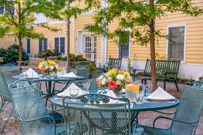 Outdoor dining area with tables and floral centerpieces