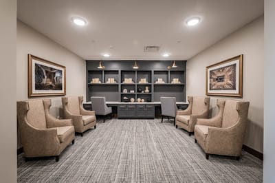 Cozy common area with armchairs and decorative shelves