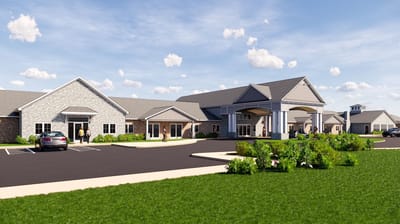 Exterior view of Cedarhurst of Topeka with gardens and vehicles