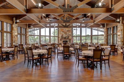 Spacious dining room with wooden tables and chairs