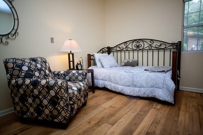 Private bedroom with a chair and lamp