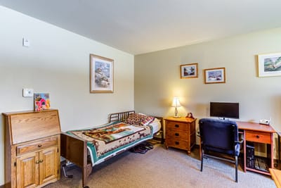 Cozy resident room with bed and desk