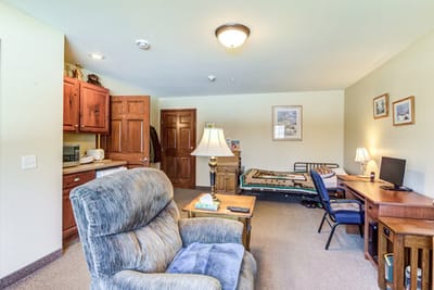 Cozy resident room with a bed and seating area