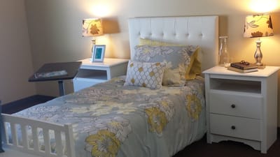 Cozy resident room with floral bedding and lamps
